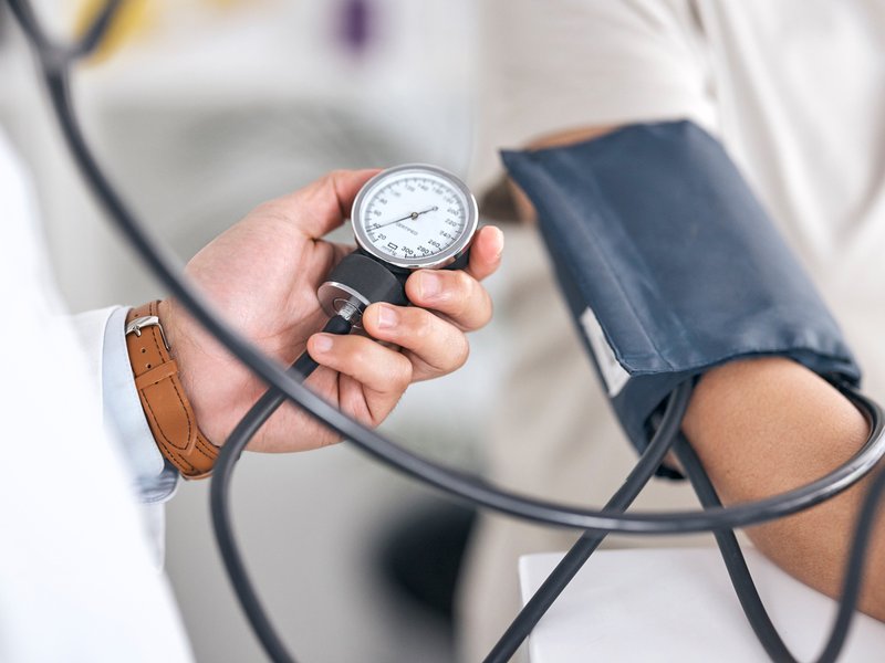 Doctor checking blood pressure with patient in consultation at hospital