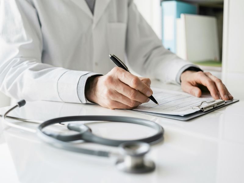 Doctor writing sick note stock image