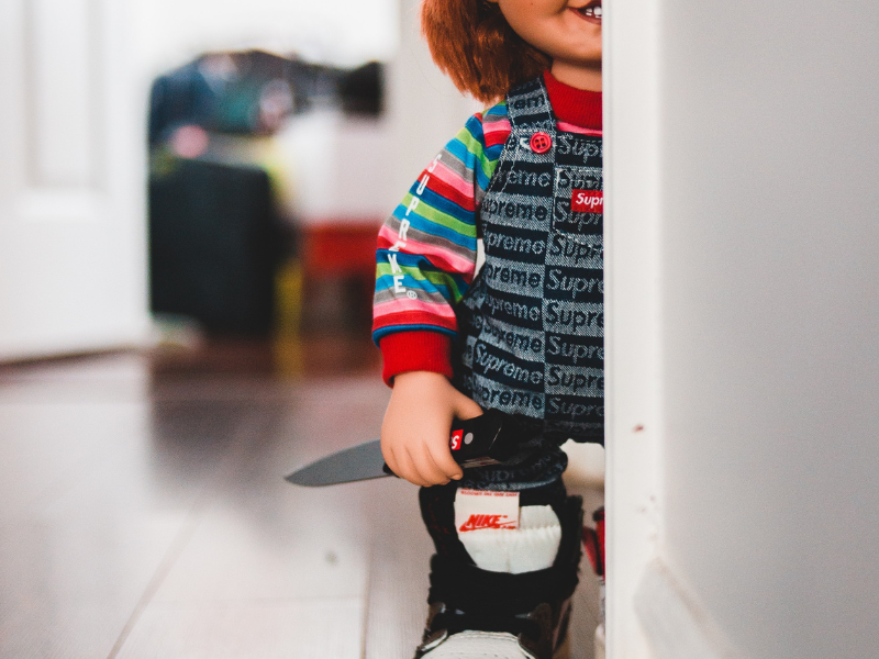 Doll with knife in trendy show at home