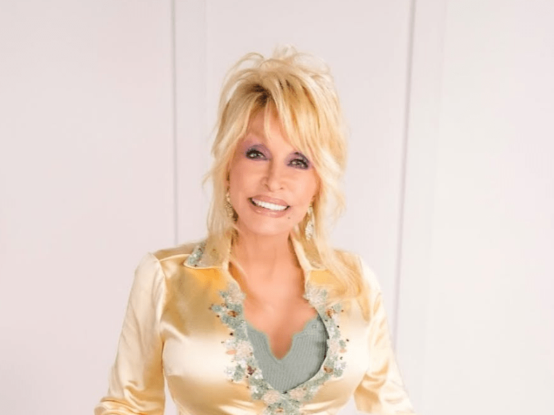 Dolly Parton wearing a silk shirt with floral details