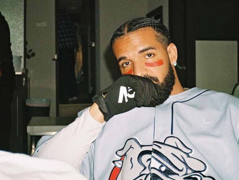 Drake chilling on couch wearing black glove