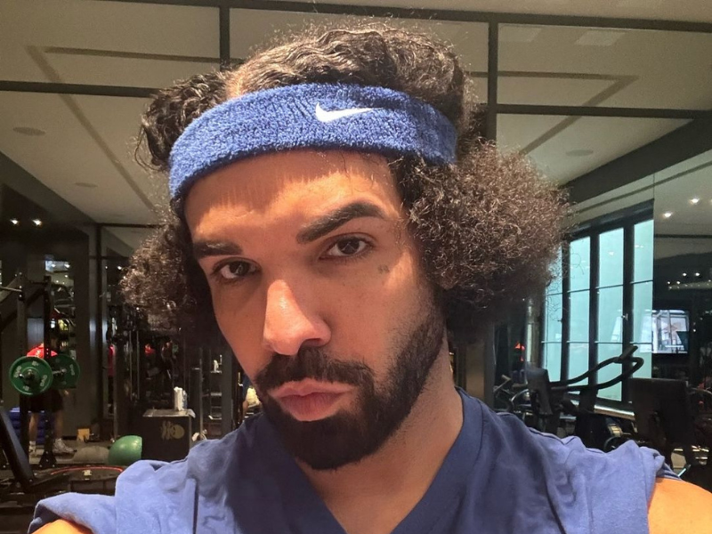 Drake making a duck face pout while taking a selfie in the gym