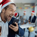 Drunk businessman screaming on the cellphone while at the office Christmas party