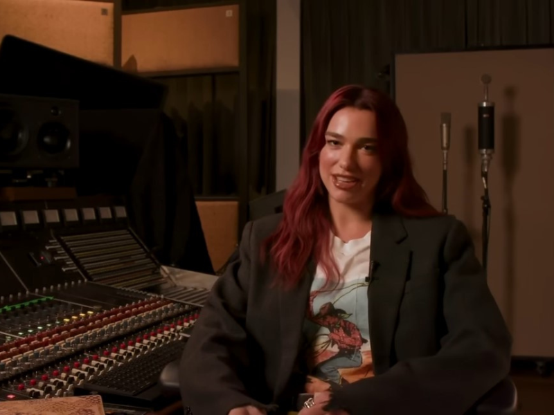 Dua Lipa sitting in a recording studio