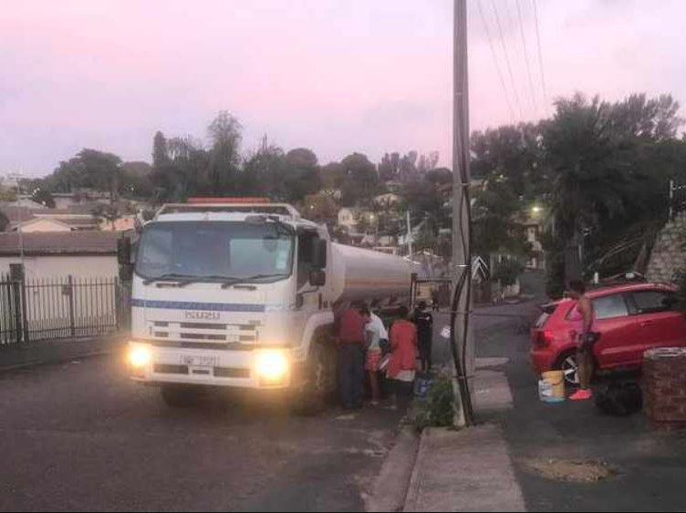 Residents fill up buckets and bottles with water from a City water tanker.