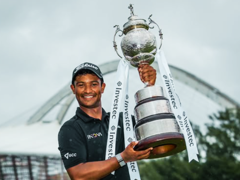 Dylan Naidoo holds the Investec SA Open trophy up in the air in Durban