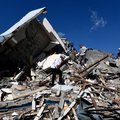 Rescuers look for survivors amid the rubble of a collapsed building in Colombia