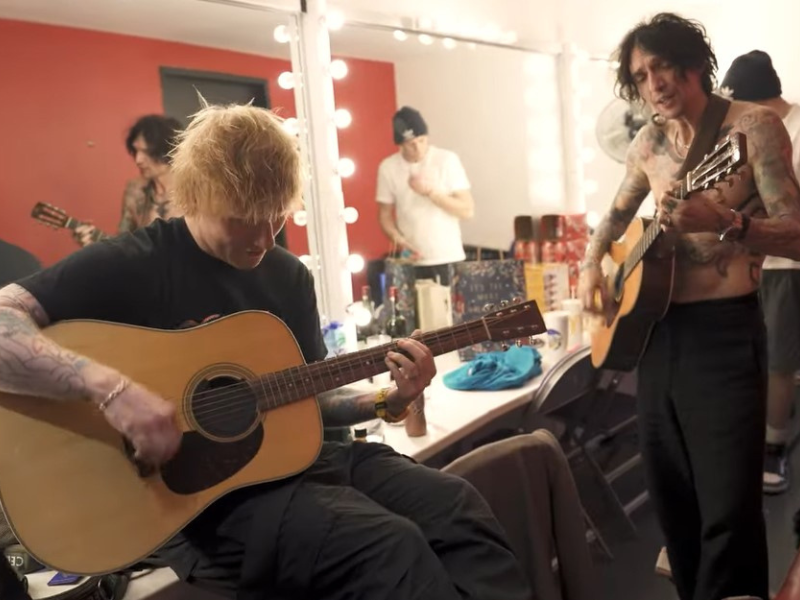 Ed Sheeran playing the guitar with The Darkness .png