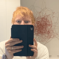 Ed Sheeran takes a mirror selfie using an iPad