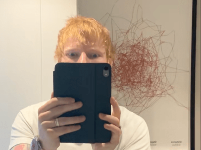 Ed Sheeran takes a mirror selfie using an iPad