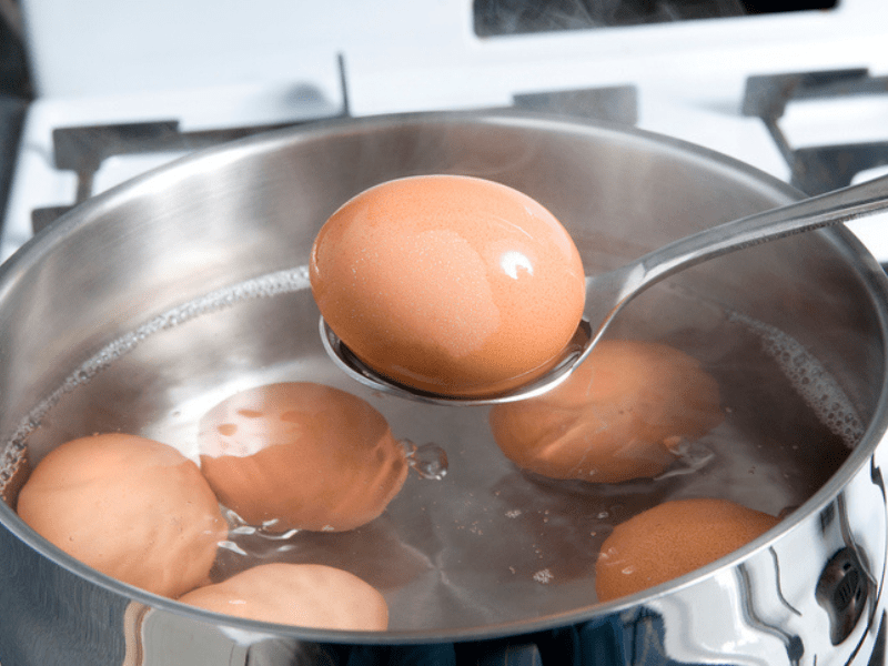 Eggs boiling in a silver pot