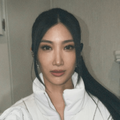 Singer Ejae wearing a white jacket