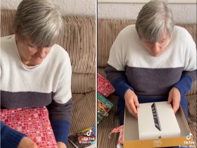 Elderly lady unwrapping a gift