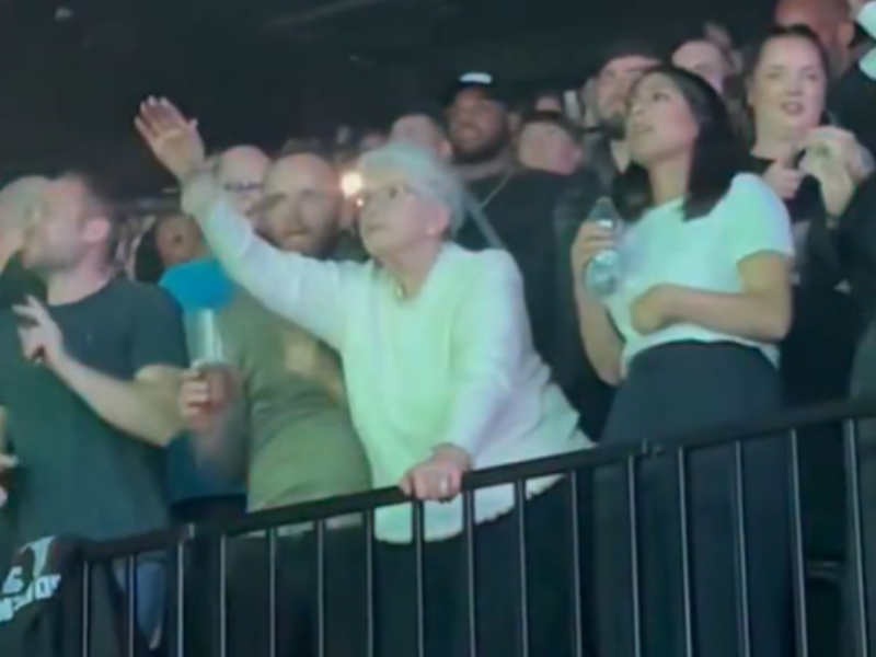 Elderly woman dancing at 50 Cent concert