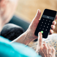 Senior woman dials emergency number on phone