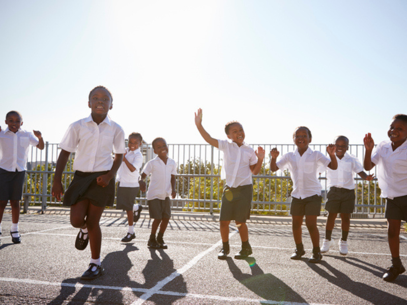 Elementary school kids having fun at the school playground