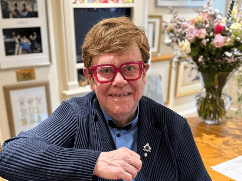 Elton John wearing red glasses
