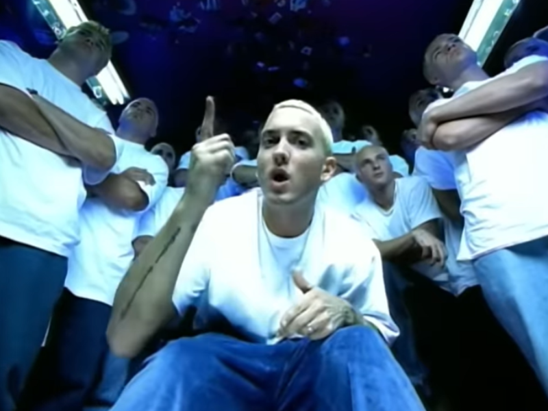 Eminem wearing blue jeans and white t-shirt