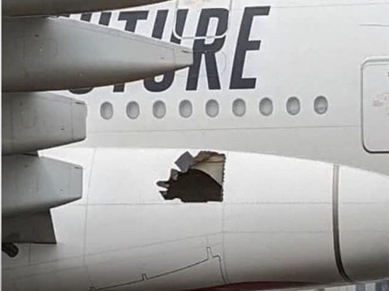 Emirates plane with a hole in its side
