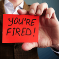 Employer shows red card with you are fired text