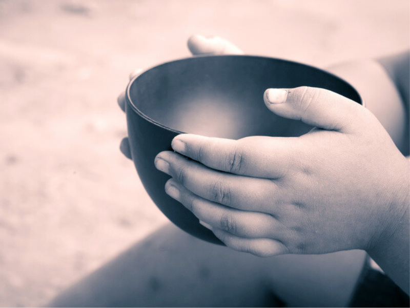 Child with empty bowl