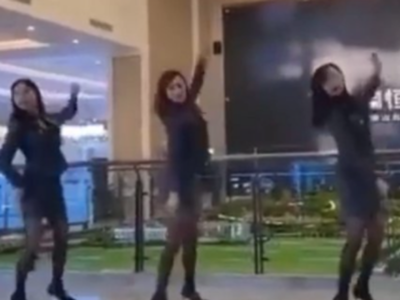 TOUGH TIMES: Chinese real-estate staff members dance to entertain their clients and get new business