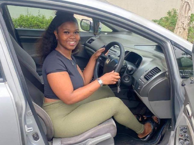 Eza Limelintaka sits at the steering wheel of her new car