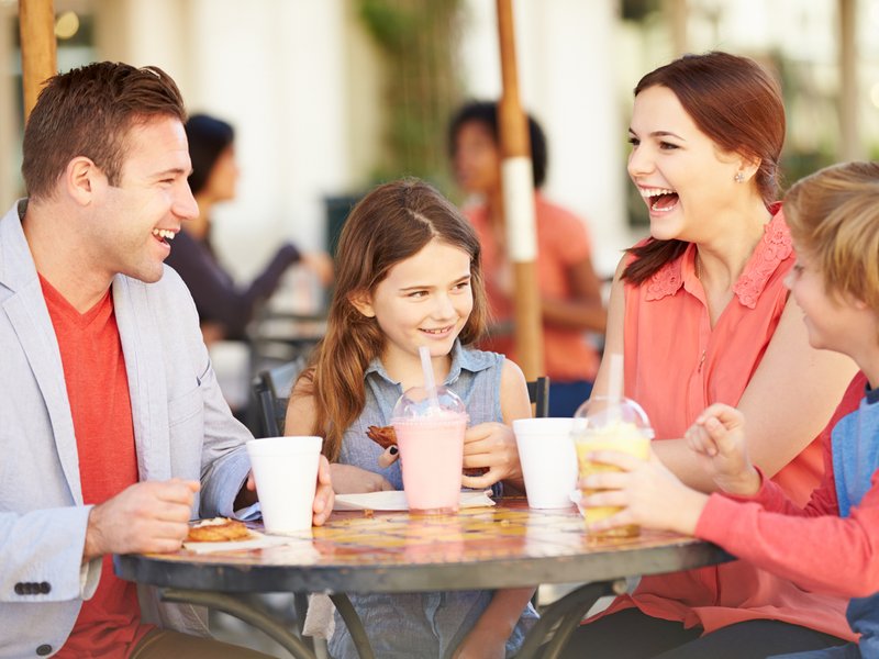Family Enjoying Snack In Cafe