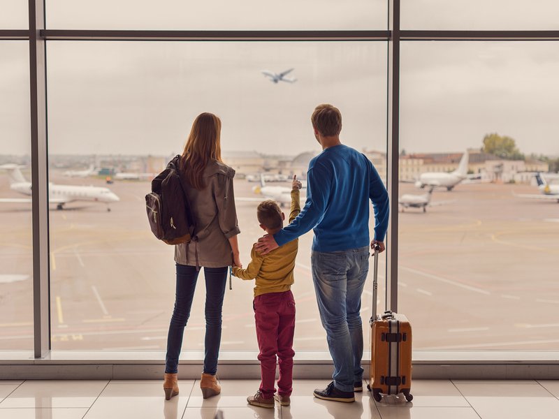Family looking out window at airport
