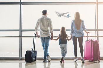 Family in airport watching flight about to take off