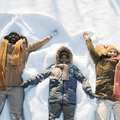 Family of three playing in the snow
