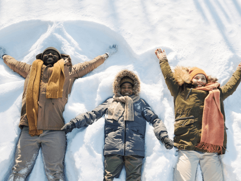 Family of three playing in the snow