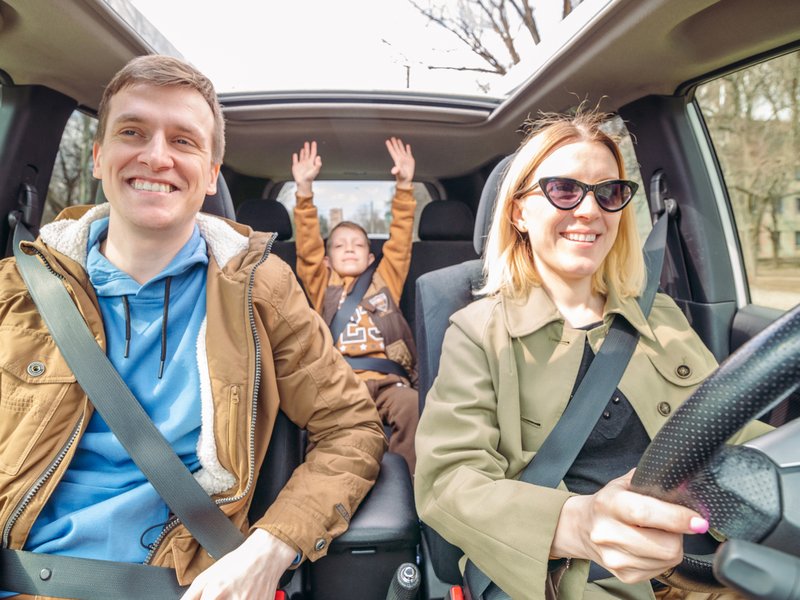 Family wearing car seats