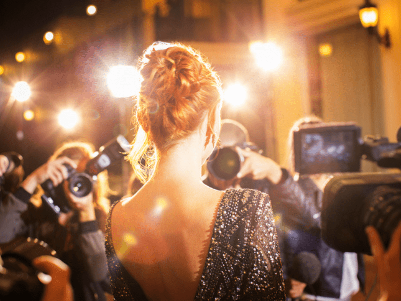 Famous  woman being photographed by paparazzi photographers