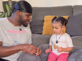 Father having a conversation with his daughter on the couch