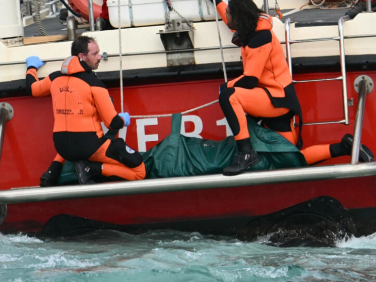 Body being retrieved from the water after yacht sinks off Sicily