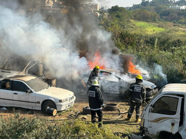 Firefighters in KZN try to put out the fire on a burning car
