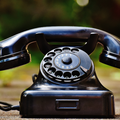 Focus photography of black rotary phone