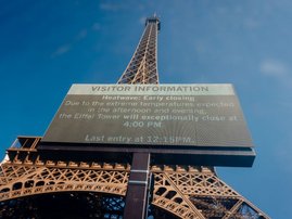 Eiffel Tower with a giant screen announcing its early closing due to heatwave in Paris