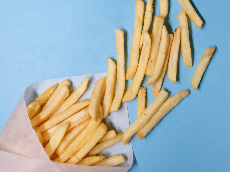 Fried potatoes on a blue background