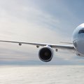 Front view of the white wide body passenger airplane flies in the air