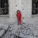 A crying Palestinian girl stands over the debris of a house hit by an Israeli strike in the south Gaza city of Khan Yunis on Wednesday
