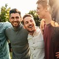 GROUP OF MEN HOLDING EACH OTHER