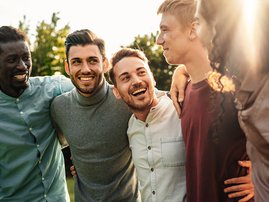 GROUP OF MEN HOLDING EACH OTHER