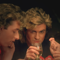 George Michael holding a glass of wine