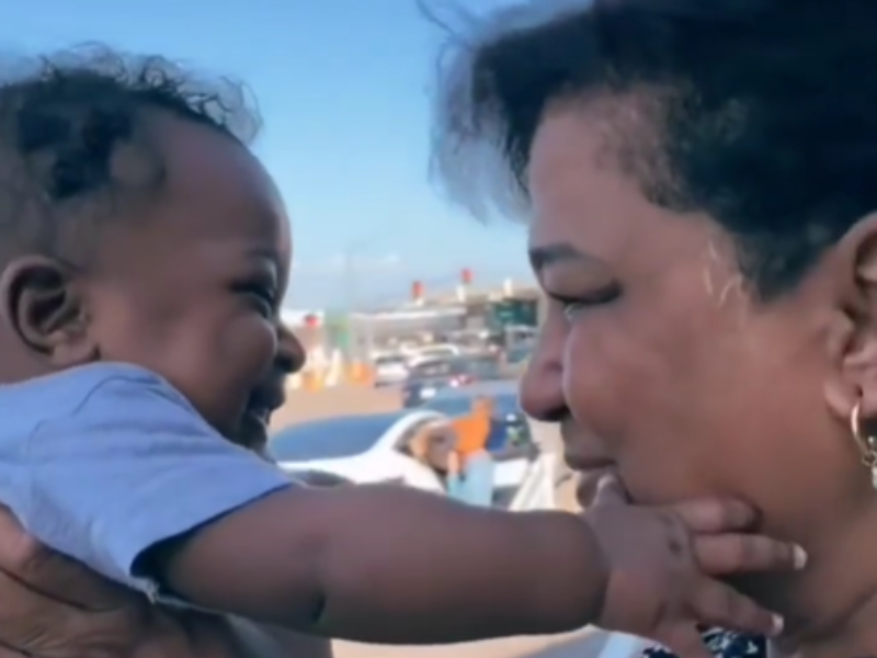 Grandmother and grandson smiling at each other