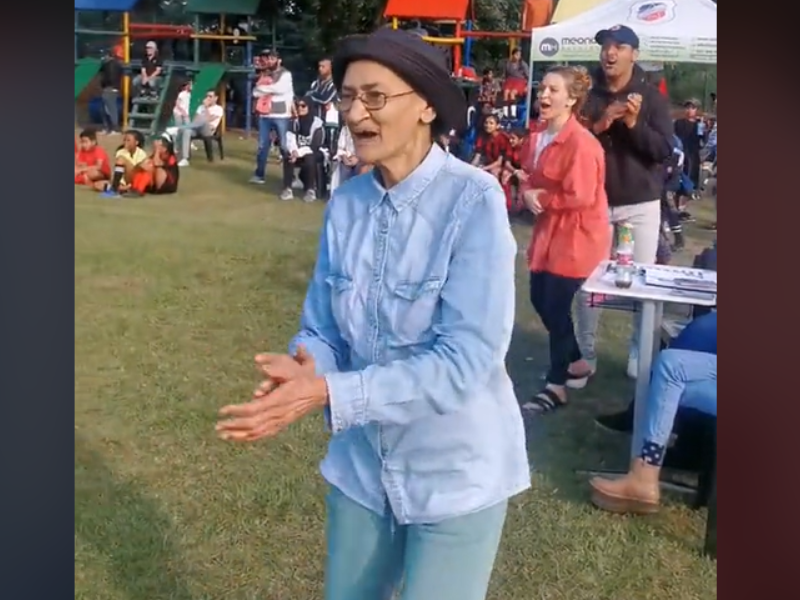 Grandmother clapping her hands at a soccer game