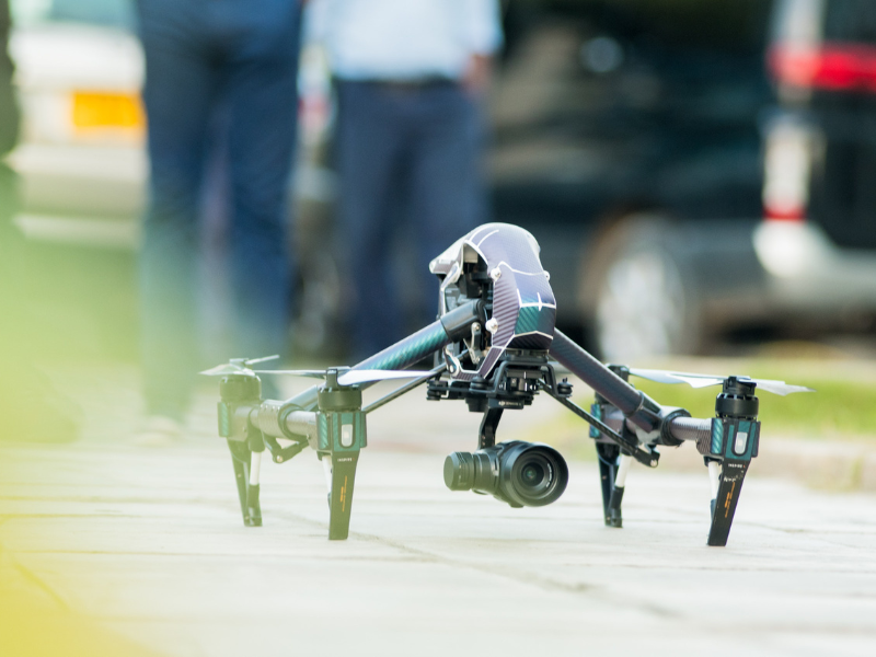 Gray and green quadcopter drone on the ground