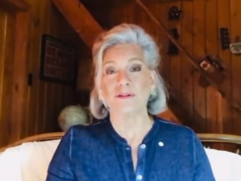Gray haired woman with blue shirt