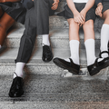Group of school children wearing grey uniforms